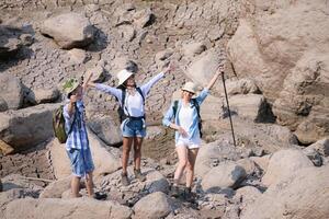 A group of friends going hiking in the streams of the tropical forest area. photo