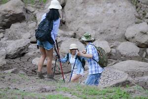 A group of friends going hiking in the streams of the tropical forest area. photo