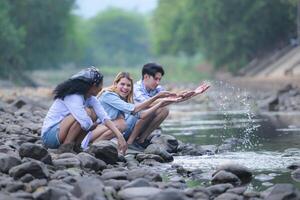 A group of friends are camping near a stream, but there is no water running. photo