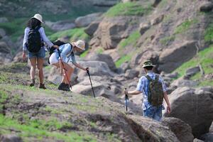A group of friends going hiking in the streams of the tropical forest area. photo