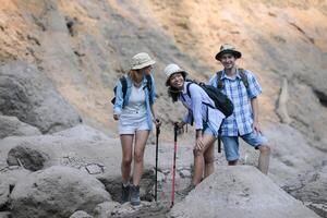 A group of friends going hiking in the streams of the tropical forest area. photo