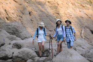 A group of friends going hiking in the streams of the tropical forest area. photo