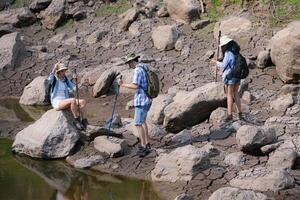 A group of friends going hiking in the streams of the tropical forest area. photo
