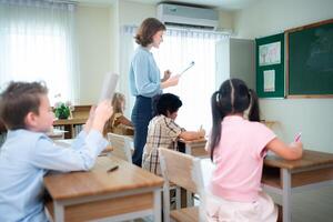 Teacher and students, Learn and study in a classroom of school where youngsters sit and listen attentively. photo