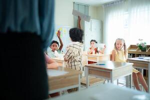 Teacher and students, Learn and study in a classroom of school where youngsters sit and listen attentively. photo