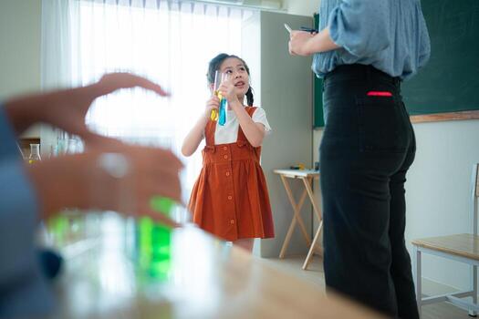 Teacher and students, Learn and experiment with science in a school science classroom. photo