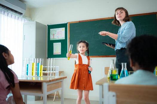 Teacher and students, Learn and experiment with science in a school science classroom. photo