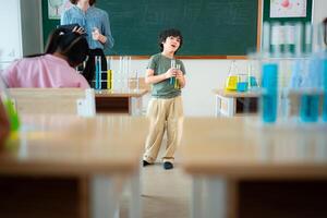 Teacher and students, Learn and experiment with science in a school science classroom. photo