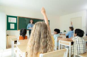 Teacher and students, Learn and study in a classroom of school where youngsters sit and listen attentively. photo