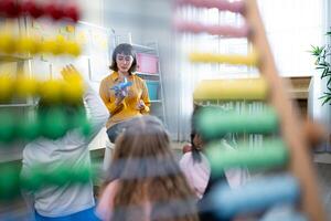 Teacher and students, Learn and study about airplanes in a classroom of school where youngsters sit and listen attentively. photo