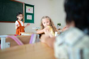 Teacher and students, Learn and study in a classroom of school where youngsters sit and listen attentively. photo