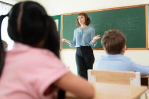 Teacher and students, Learn and study in a classroom of school where youngsters sit and listen attentively. photo