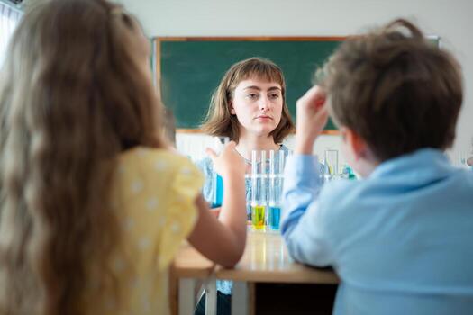Teacher and students, Learn and experiment with science in a school science classroom. photo