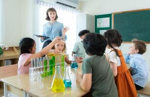 Teacher and students, Learn and experiment with science in a school science classroom. photo