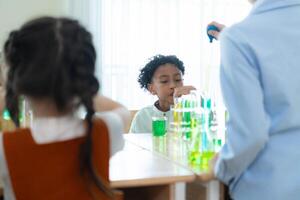 Teacher and students, Learn and experiment with science in a school science classroom. photo