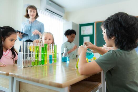 Teacher and students, Learn and experiment with science in a school science classroom. photo