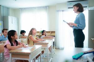 Teacher and students, Learn and study in a classroom of school where youngsters sit and listen attentively. photo