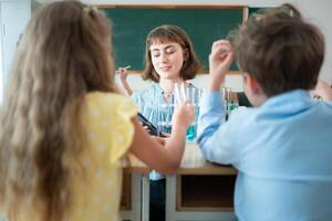 Teacher and students, Learn and experiment with science in a school science classroom. photo