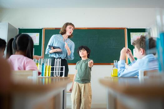 Teacher and students, Learn and experiment with science in a school science classroom. photo