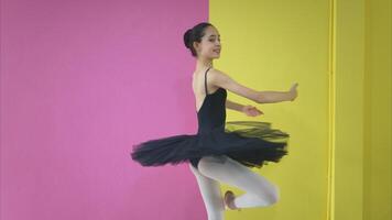 A girl ballet student practices ballet dancing at home with a white background photo