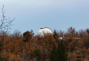 A white dome sitting on top of a hill photo