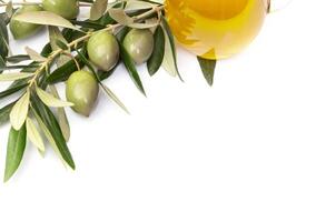 Olives and a bottle of olive oil photo
