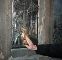 A man touching a bronze plaque photo