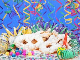 A table with a bunch of colorful confetti and a bunch of doughnuts photo