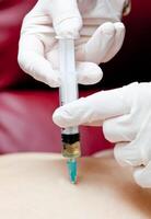 A person getting an injection into their arm photo