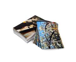 A stack of four photographs on a white surface photo