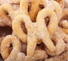 A bowl of sugar - coated cinnamon twists photo