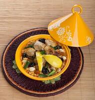 A plate with food on it and a yellow bowl photo
