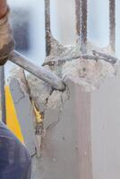 A man is using a hammer to break concrete photo