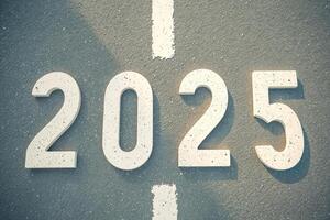 white 2025 numbers on asphalt background photo