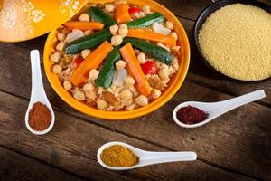 A bowl of food with spices and vegetables photo