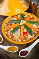 A plate of food with spices and vegetables on a table photo