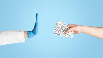 Unrecognizable female doctor refusing bribe from patient on light background, close up of hands photo