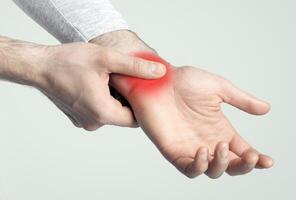 Wrist pain concept. Sore spot highlighted in red, empty space photo