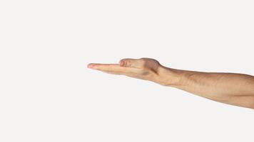Millennial man displaying something against light background, close up. Empty space for design photo