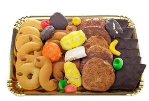 A tray of assorted cookies and candy on a white background photo