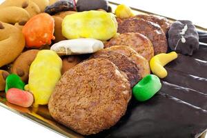 A tray of assorted cookies and candies photo