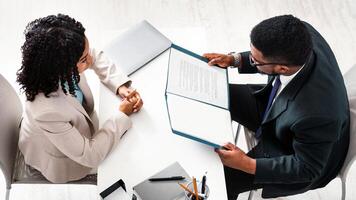 Above view of HR manager with resume and vacancy applicant on job interview at office. Copy space photo