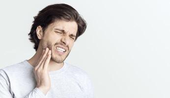 Dental problems concept. Man suffering from bad toothache, empty space photo