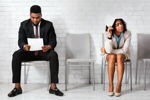 Exhausted vacancy applicants waiting for work interview at corporate office. Panorama photo