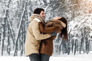 Winter Date. Loving Boyfriend And Girlfriend Hugging Laughing Standing In Snowy Park In The Morning. Panorama, Copy Space photo
