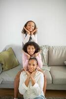 Two daughters pose playfully at home, showcasing their affection for their mother. The warm atmosphere reflects love and care, with smiles highlighting their close bond. photo