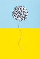 Balloon made of letters on a yellow and blue background. Conceptual image regarding literature, language and freedom of expression. photo