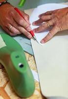 Shoe designer working with leather. photo