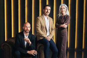 In a contemporary office, three European business professionals pose confidently. They represent leadership roles, showcasing a collaborative and innovative corporate atmosphere. photo