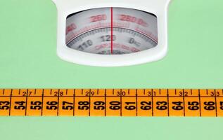 Bathroom scale with a measuring tape photo